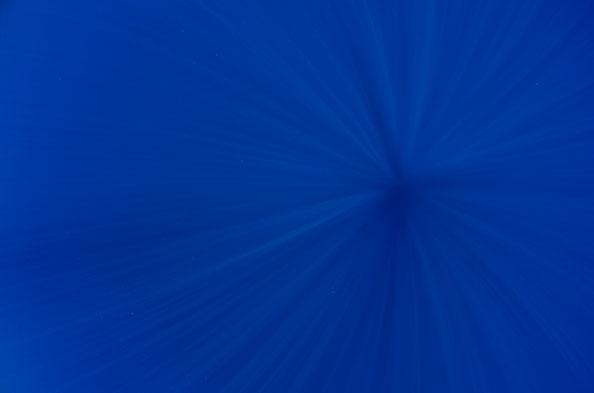 sunrays create radial pattern in clear blue ocean water